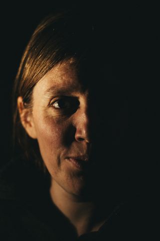 Close up portrait of a woman with light on her right side