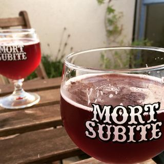 2 Mort Subite glasses with Mort Subite beer poured in