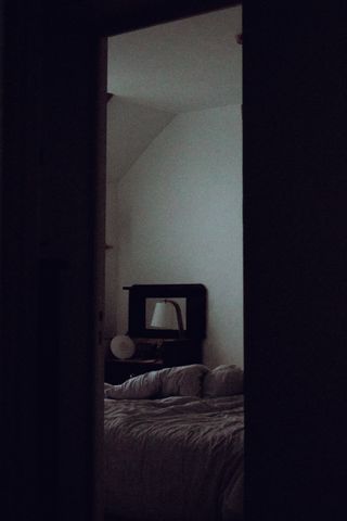 Glimpse of a bedroom in the early morning through the door frame
