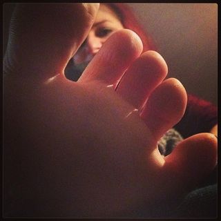 The face of a woman through her toes