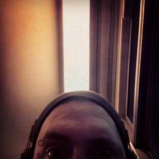 Self-portrait with lines on the ceiling of a train