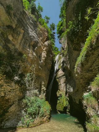 A blue cascade in a canyon
